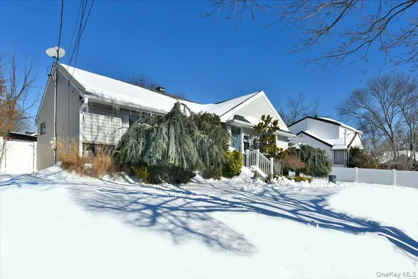 a view of a house with snow on the road