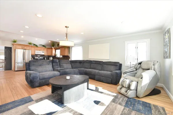 a living room with furniture and a chandelier