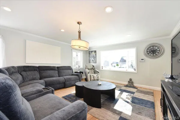 a living room with furniture and a chandelier