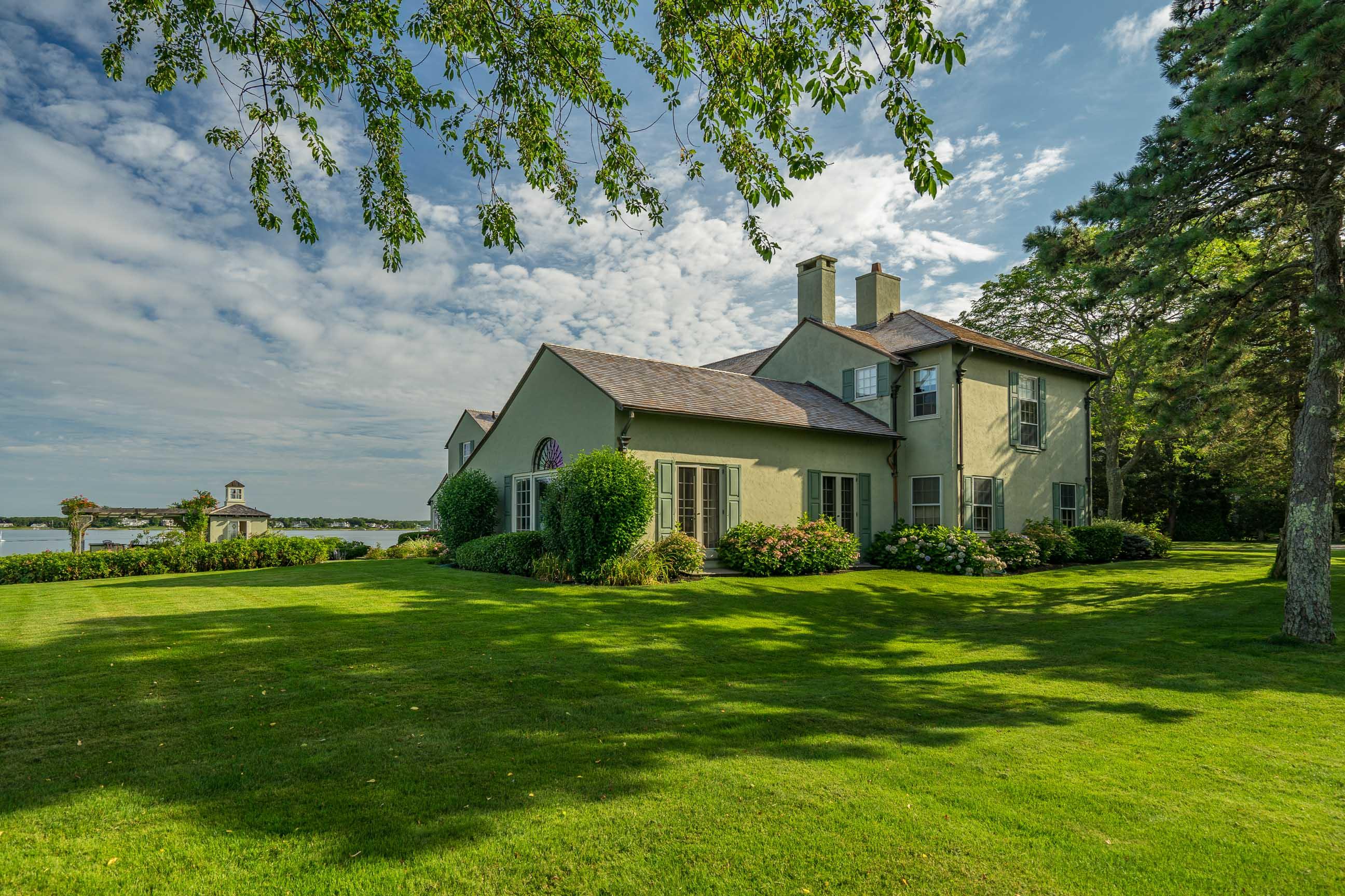 986 Sea View Avenue Osterville, MA 02655 - Photo 7 of 35 a front view of a house with a garden