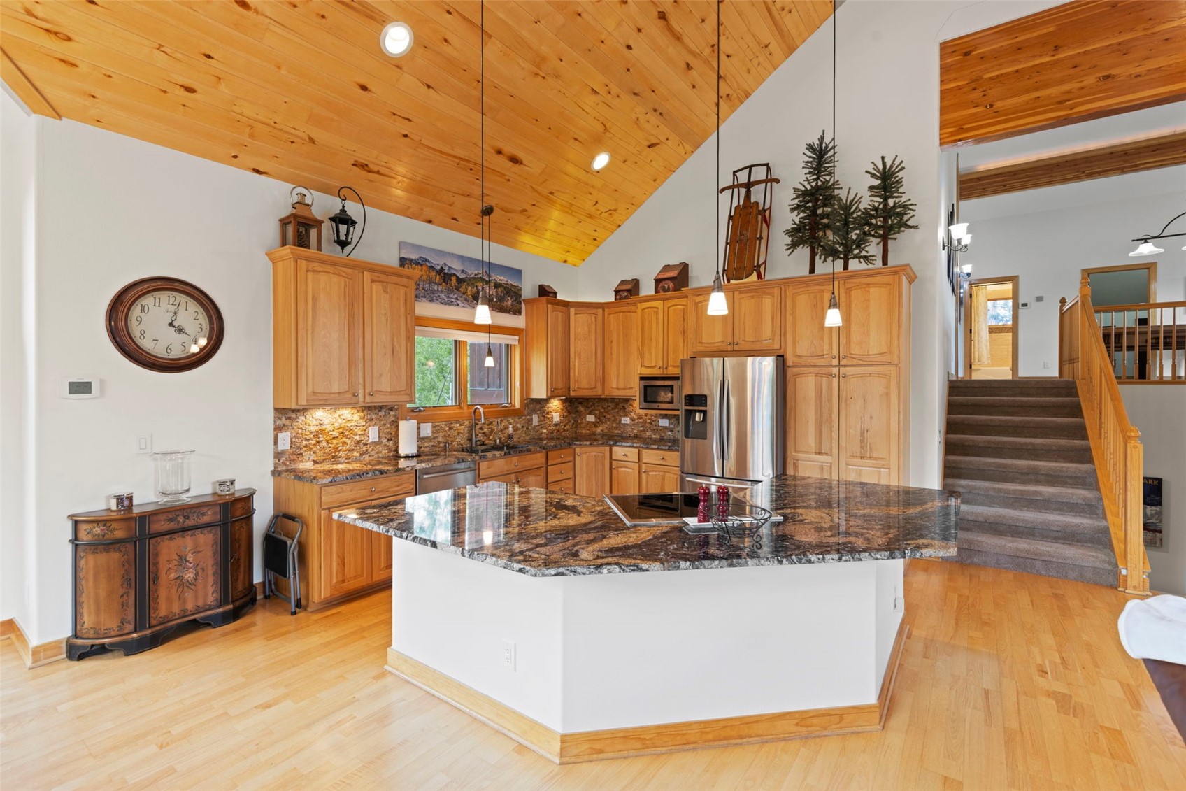 736 Wild Rose Road Silverthorne, CO 80498 - Photo 11 of 49 Kitchen featuring appliances with stainless steel finishes, light wood-style floors, tasteful backsplash, healthy amount of natural light, and wooden ceiling