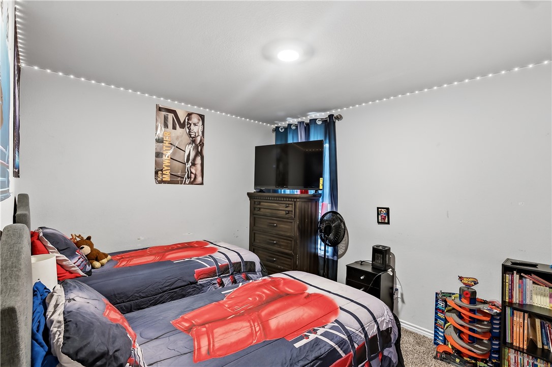 2009 Chief Street Bryan, TX 77807 - Photo 16 of 27 a bedroom with a bed and a flat screen tv