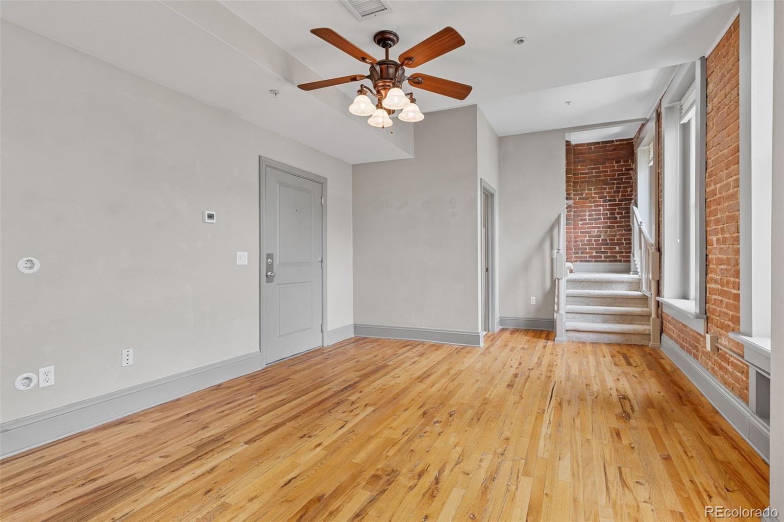 3211 Zuni Street, Unit 9 Denver, CO 80211 - Photo 11 of 36 a view of an empty room with wooden floor and a window