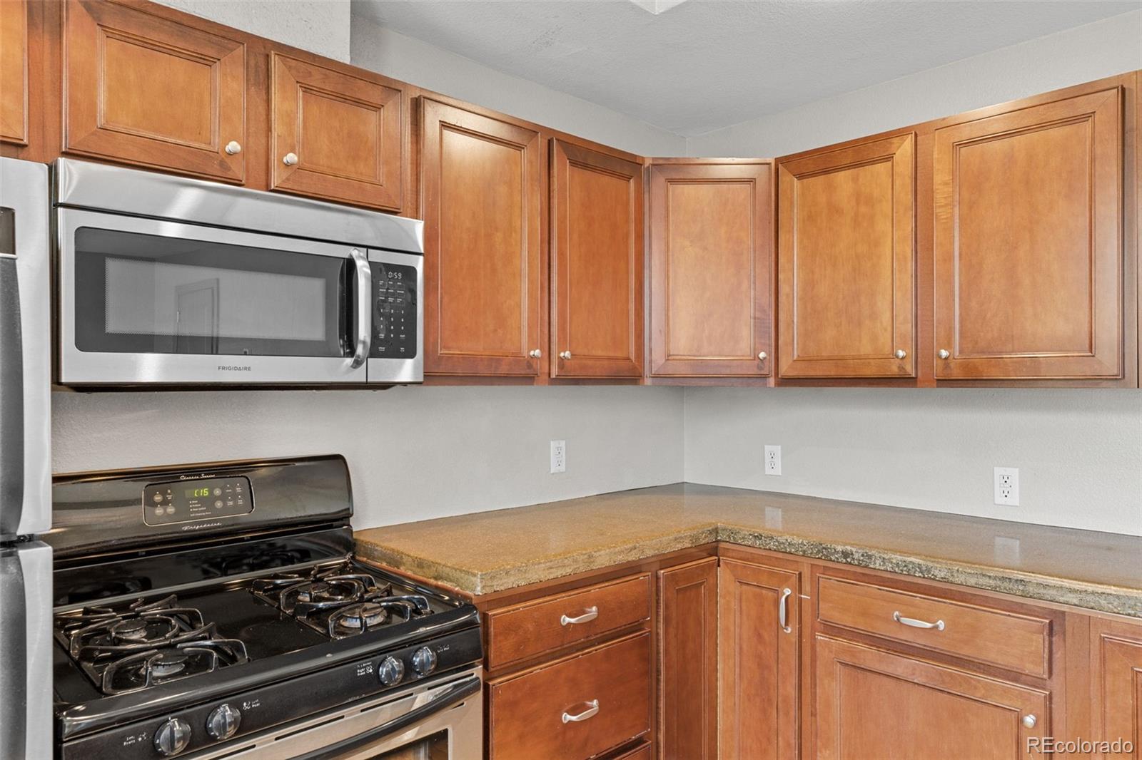 3211 Zuni Street, Unit 9 Denver, CO 80211 - Photo 16 of 36 a kitchen with granite countertop a stove and a microwave