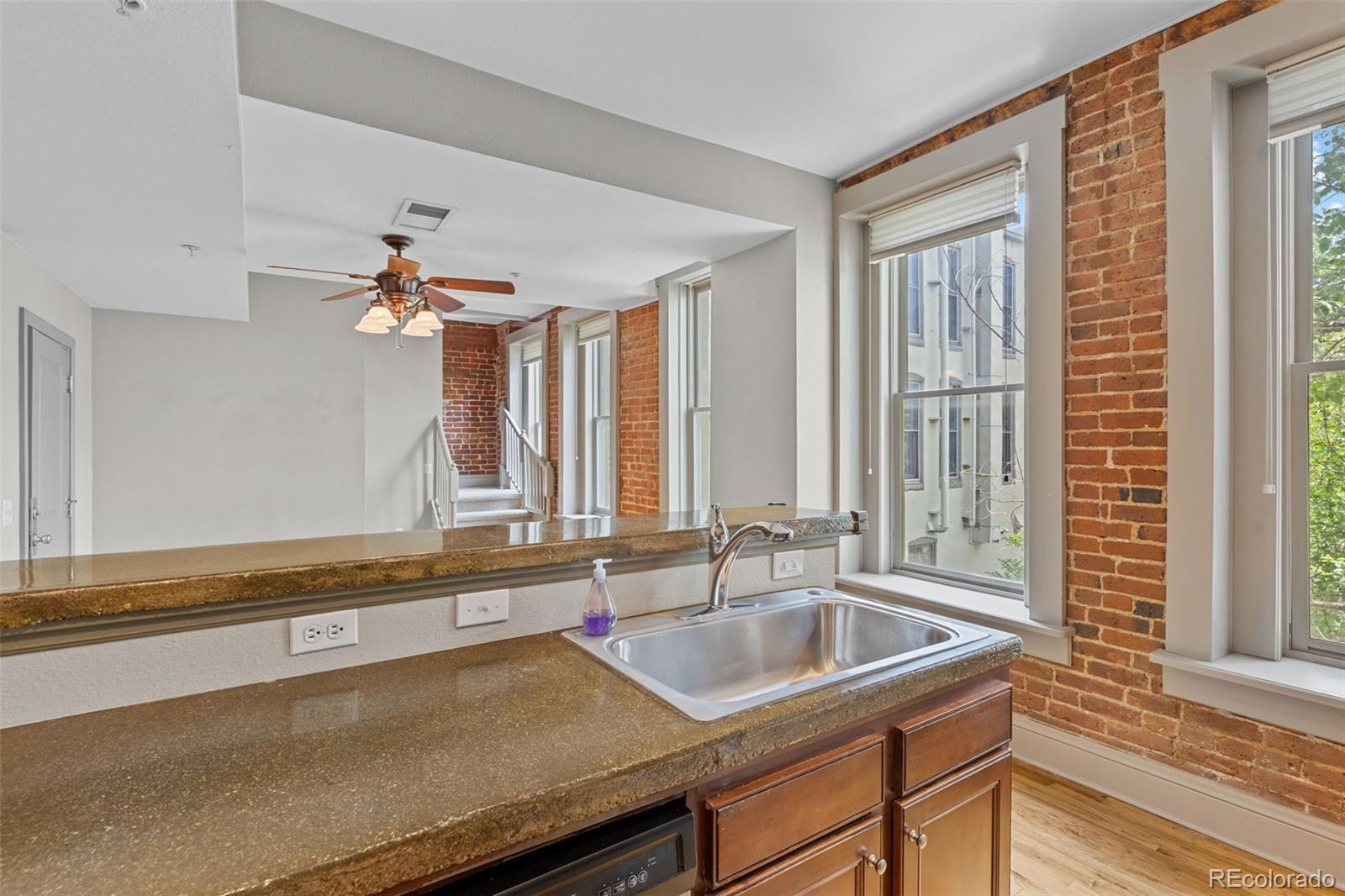 3211 Zuni Street, Unit 9 Denver, CO 80211 - Photo 17 of 36 a view of a kitchen with a sink and wooden floor