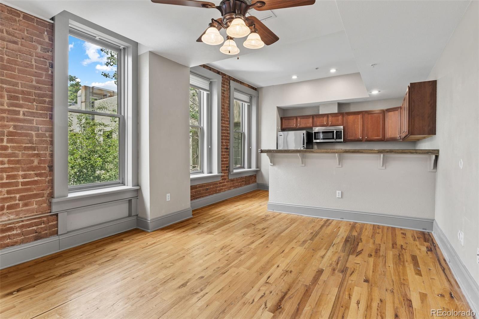 3211 Zuni Street, Unit 9 Denver, CO 80211 - Photo 2 of 36 a view of kitchen and window with wooden floor