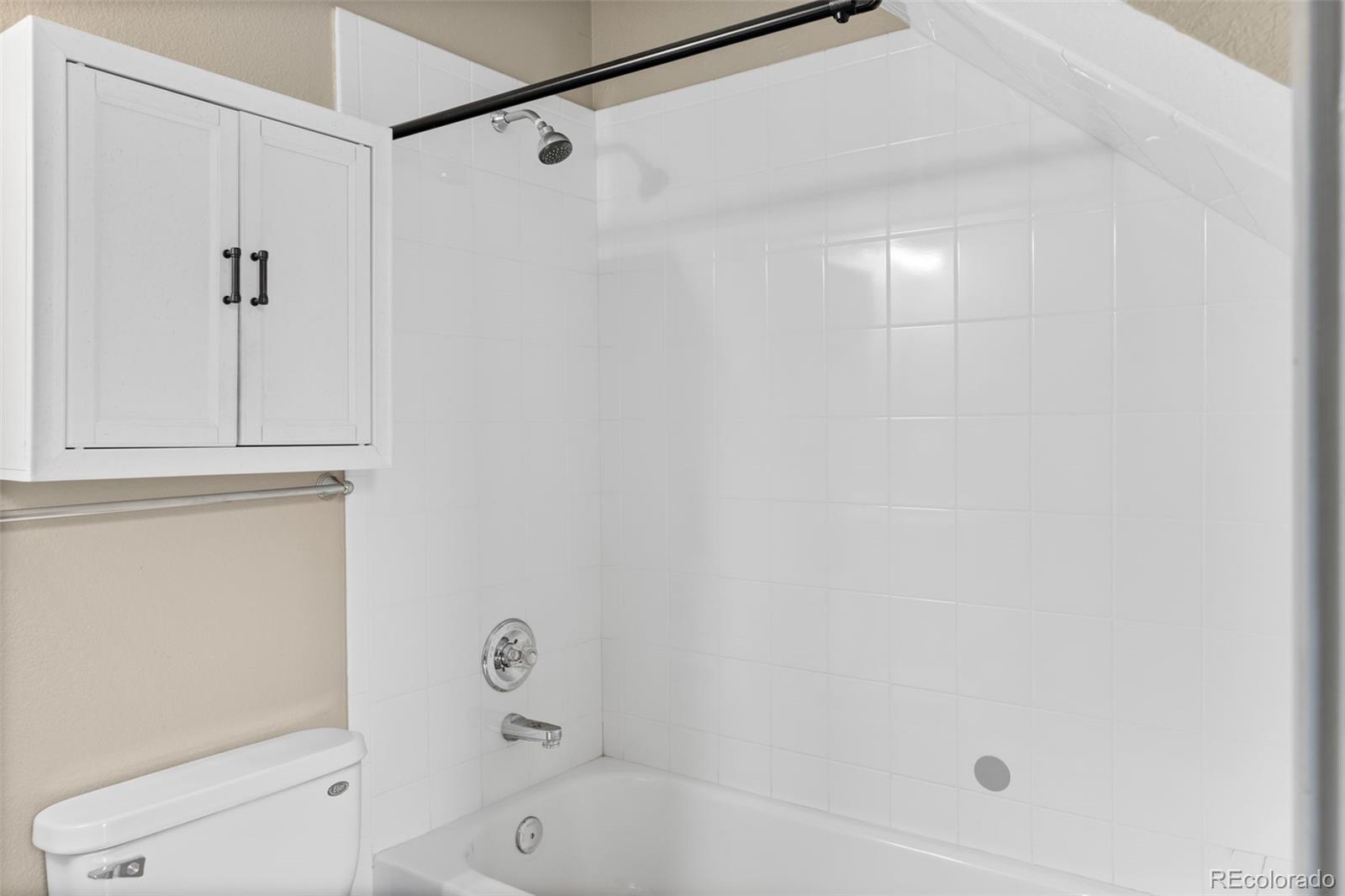 3211 Zuni Street, Unit 9 Denver, CO 80211 - Photo 21 of 36 a bathroom with a shower and a toilet