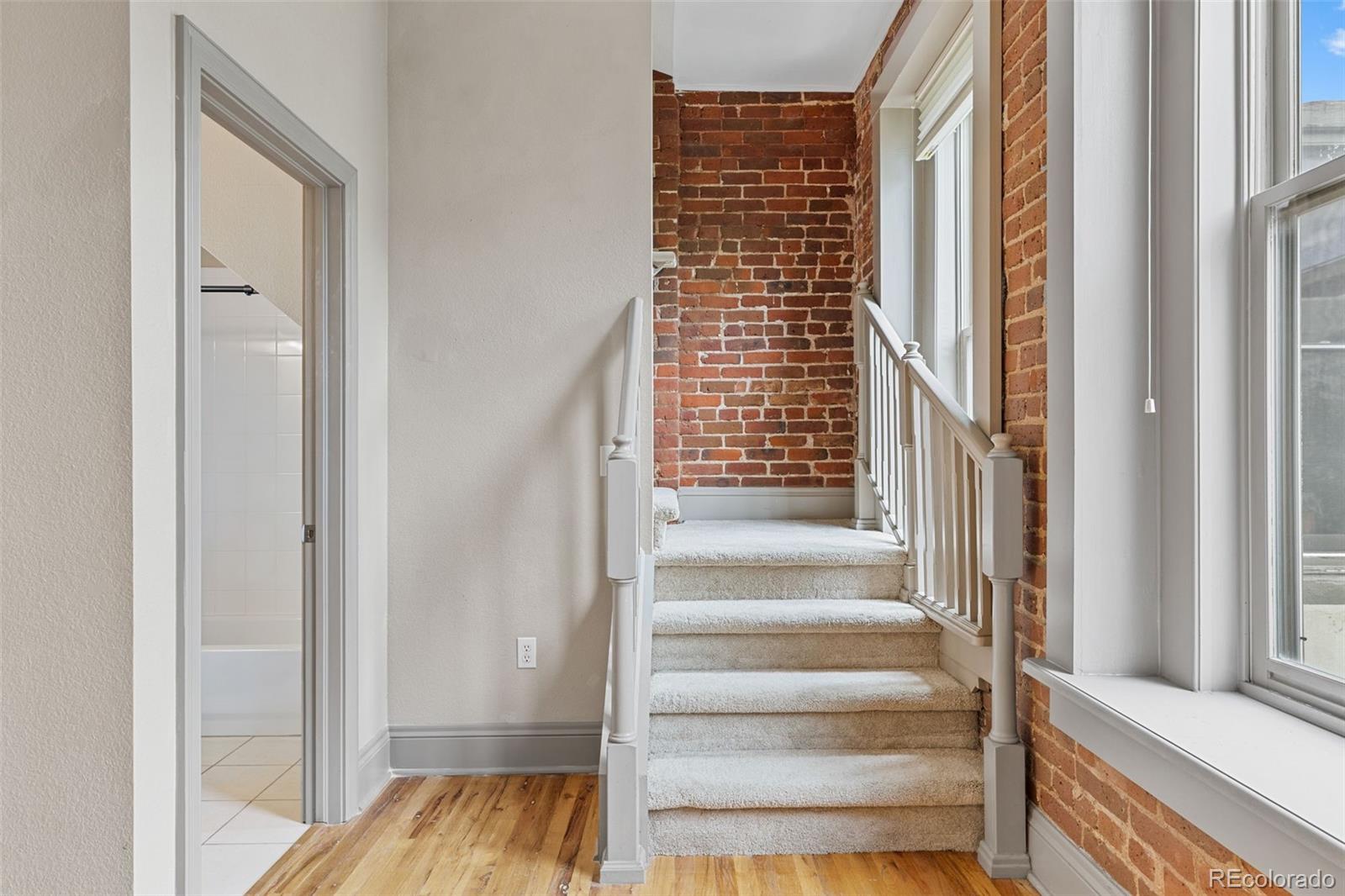 3211 Zuni Street, Unit 9 Denver, CO 80211 - Photo 22 of 36 a view of a room with wooden floor and windows