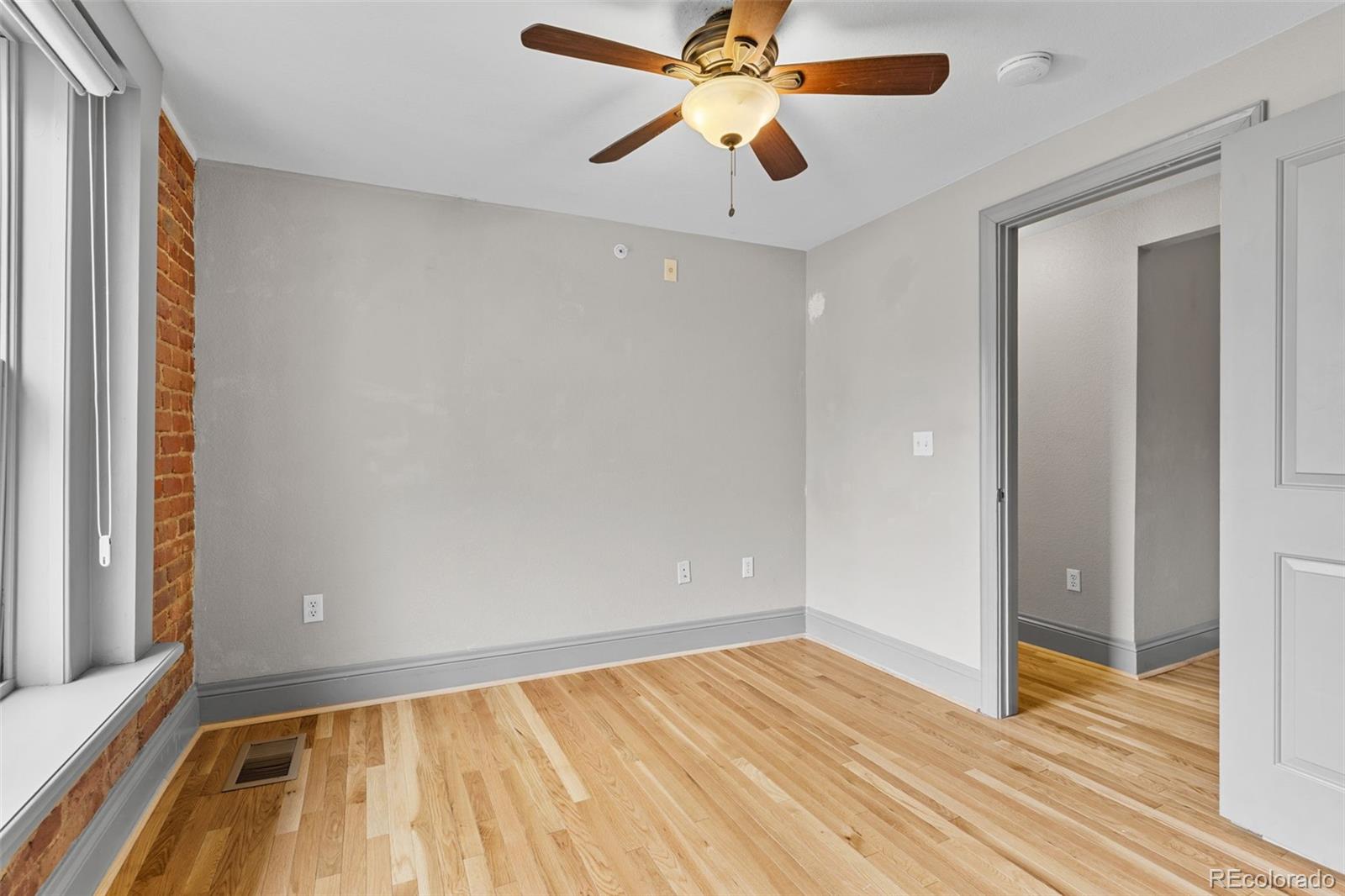 3211 Zuni Street, Unit 9 Denver, CO 80211 - Photo 27 of 36 wooden floor in an empty room with a window