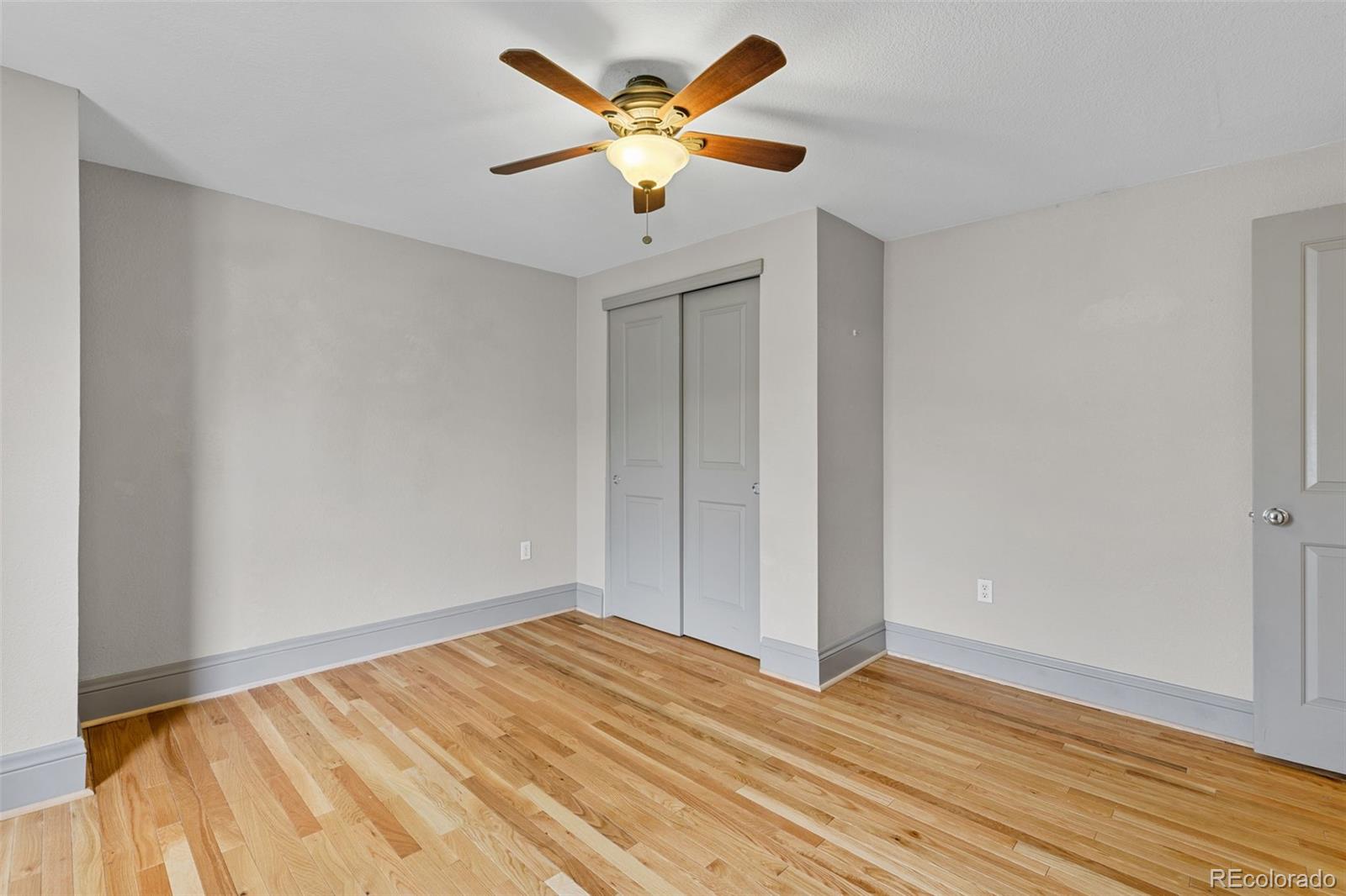 3211 Zuni Street, Unit 9 Denver, CO 80211 - Photo 30 of 36 a view of a room with wooden floor and a ceiling fan