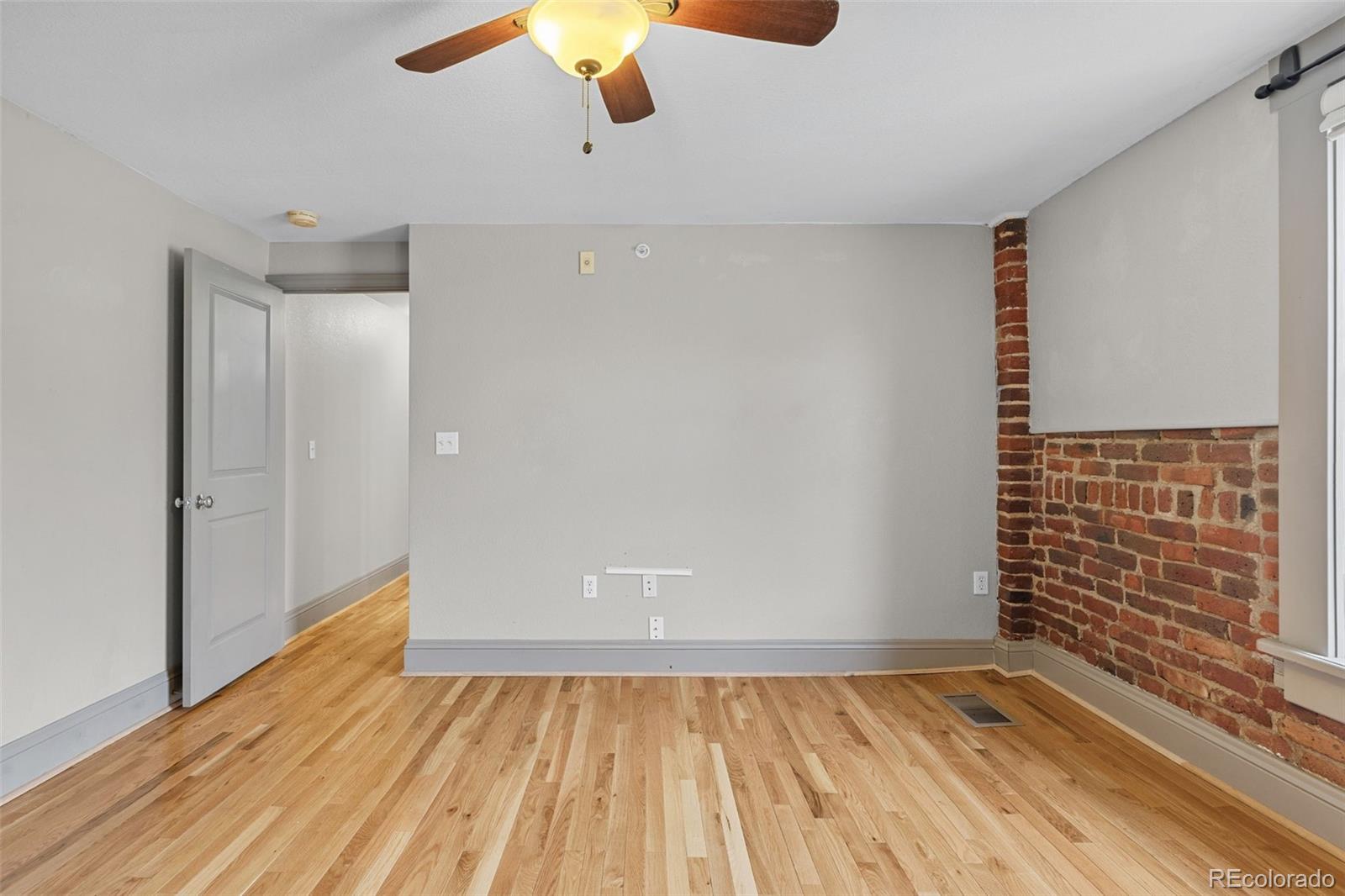 3211 Zuni Street, Unit 9 Denver, CO 80211 - Photo 32 of 36 a view of an empty room with wooden floor and a window