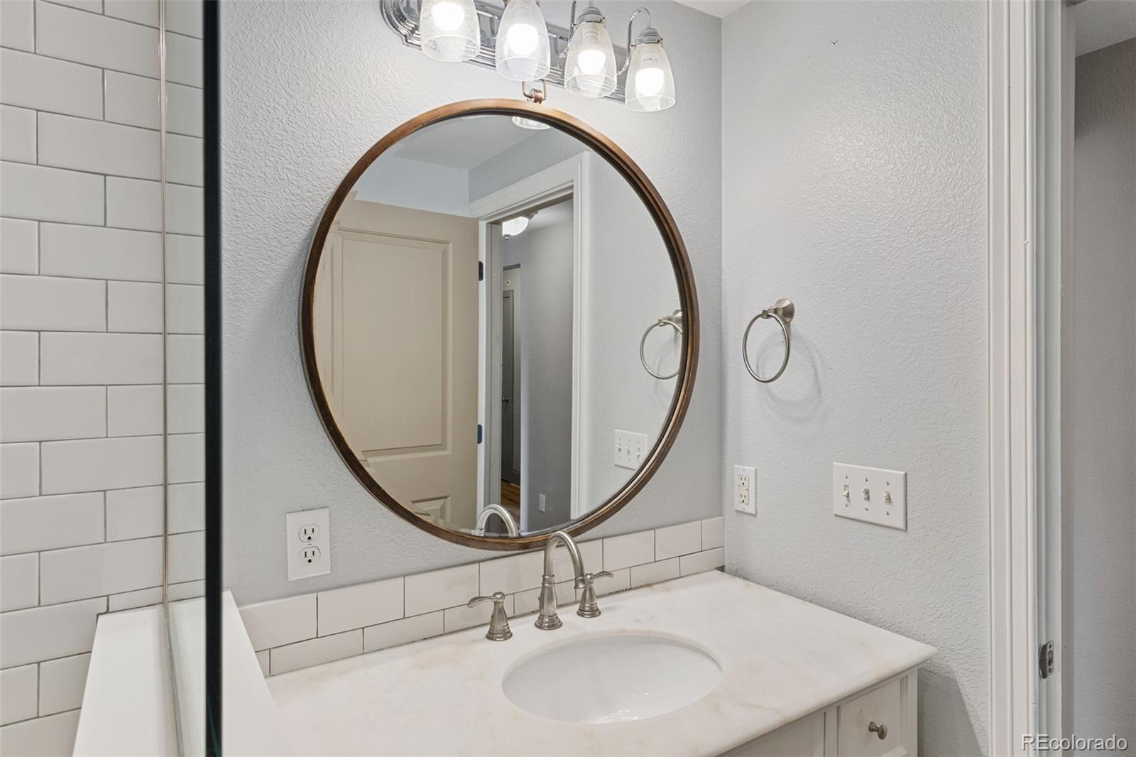 3211 Zuni Street, Unit 9 Denver, CO 80211 - Photo 35 of 36 a bathroom with a sink and a mirror