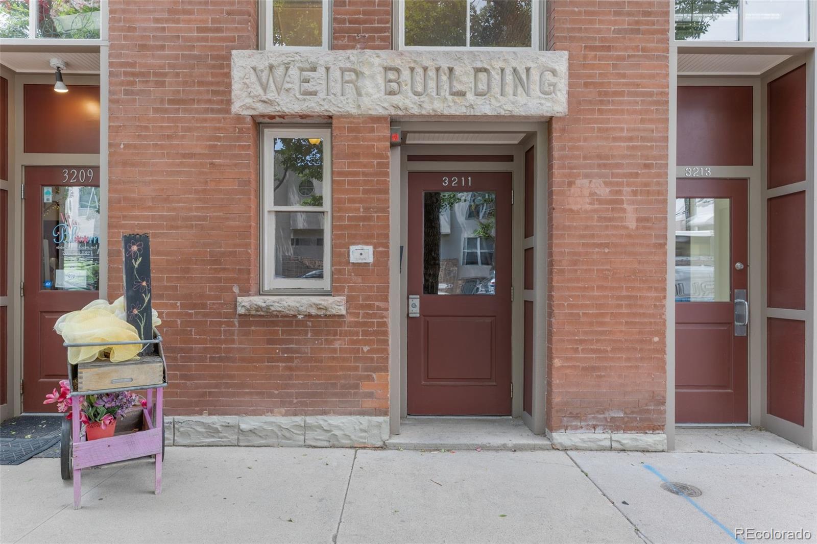 3211 Zuni Street, Unit 9 Denver, CO 80211 - Photo 4 of 36 a view of brick building with a bench in front door
