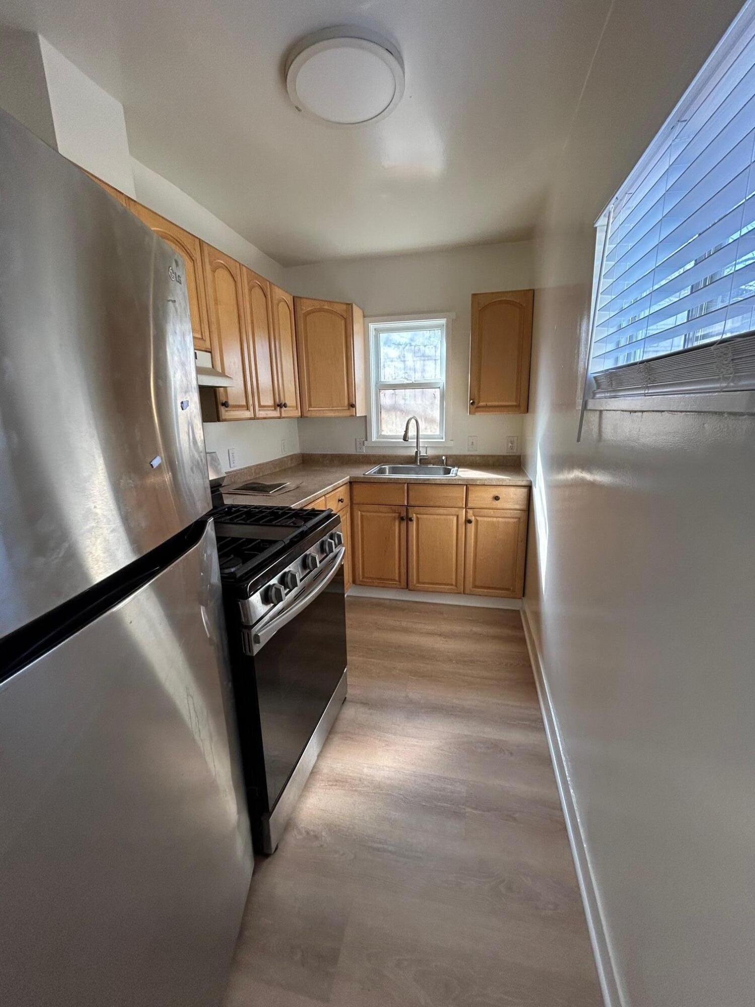 810 East Canon Perdido Street, Unit A Santa Barbara, CA 93103 - Photo 5 of 12 a kitchen with a stove cabinets and a window