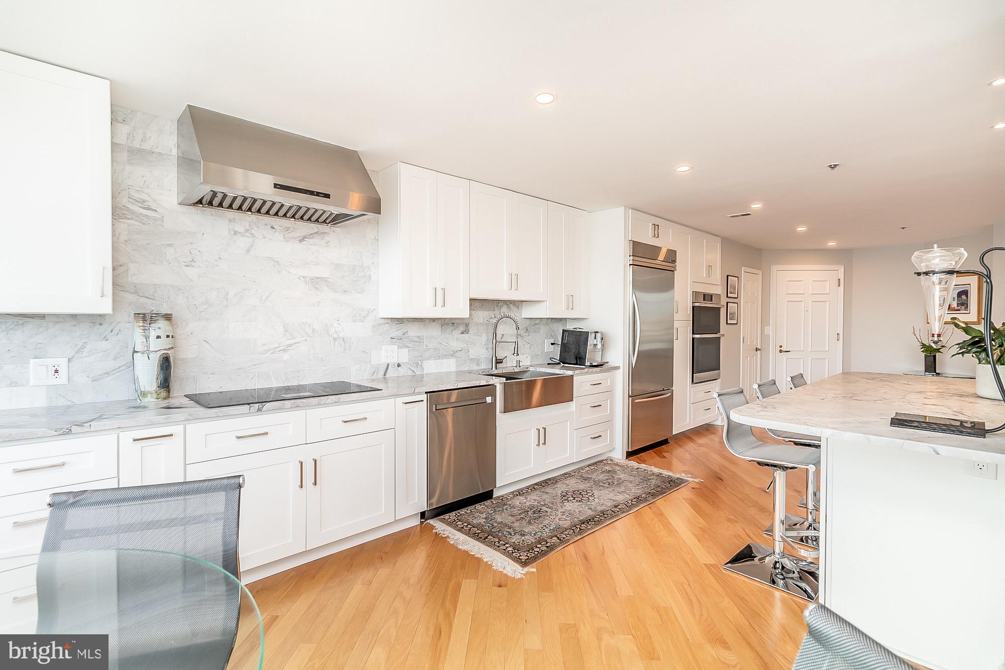 100 Harborview Drive, Unit 1001 Baltimore, MD 21230 - Photo 10 of 64 Induction cooktop with range hood