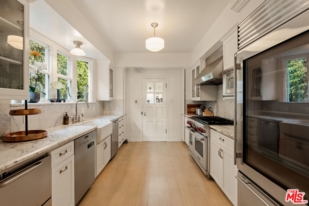 501 Palisades Beach Road Santa Monica, CA 90402 - Photo 11 of 29 a large kitchen with stainless steel appliances granite countertop a stove and a sink