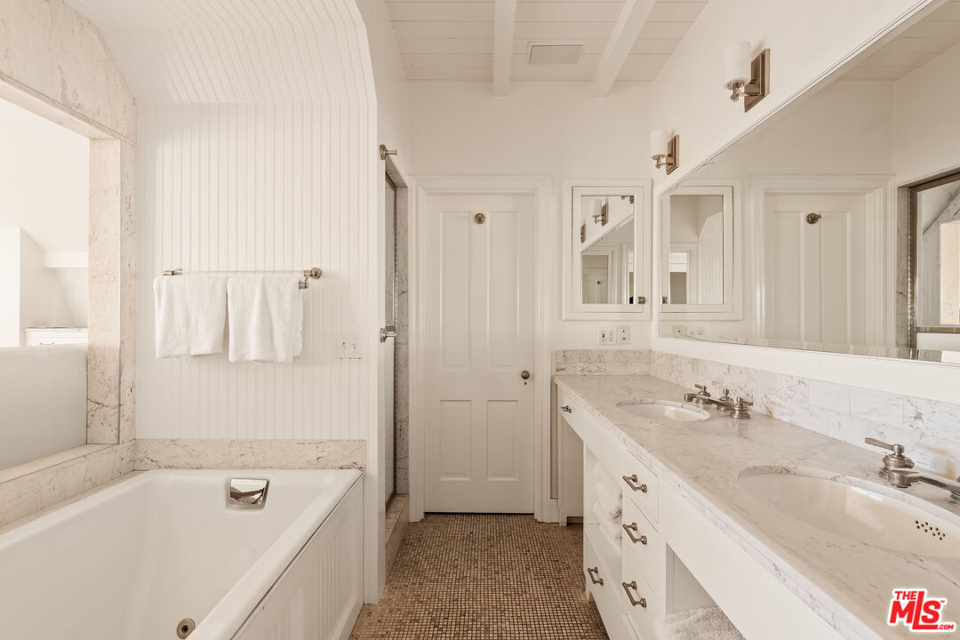 501 Palisades Beach Road Santa Monica, CA 90402 - Photo 21 of 29 a spacious bathroom with a granite countertop tub sink and mirror