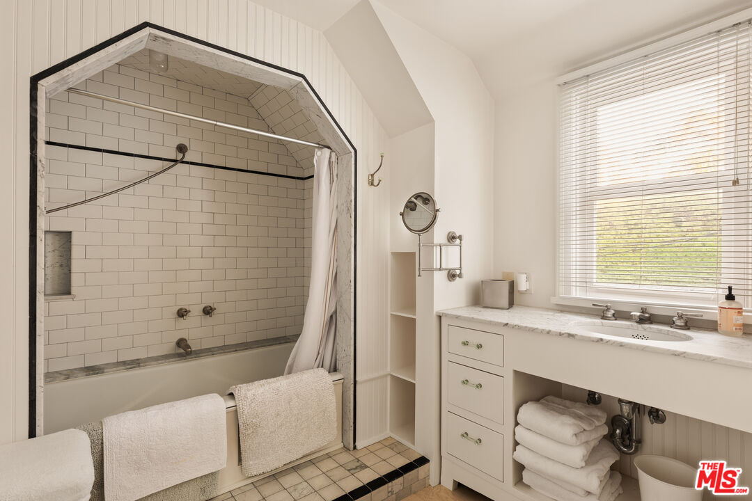 501 Palisades Beach Road Santa Monica, CA 90402 - Photo 25 of 29 a bathroom with a granite countertop sink a mirror and shower