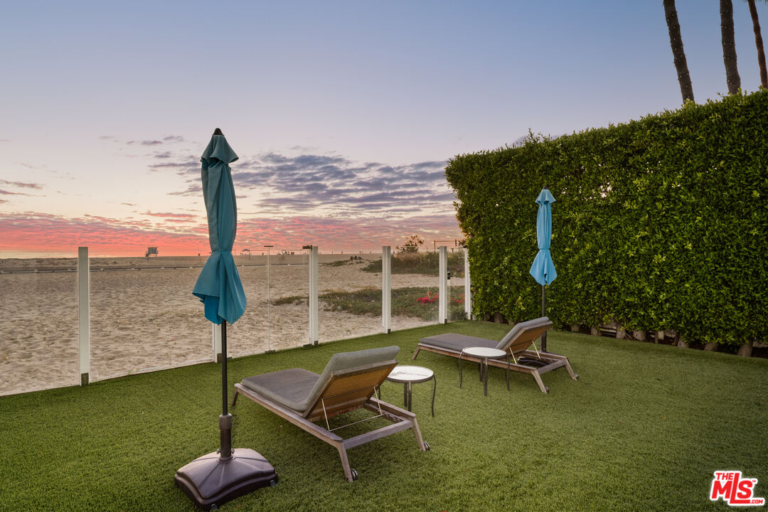 501 Palisades Beach Road Santa Monica, CA 90402 - Photo 3 of 29 a blue bench sitting in the middle of a lake