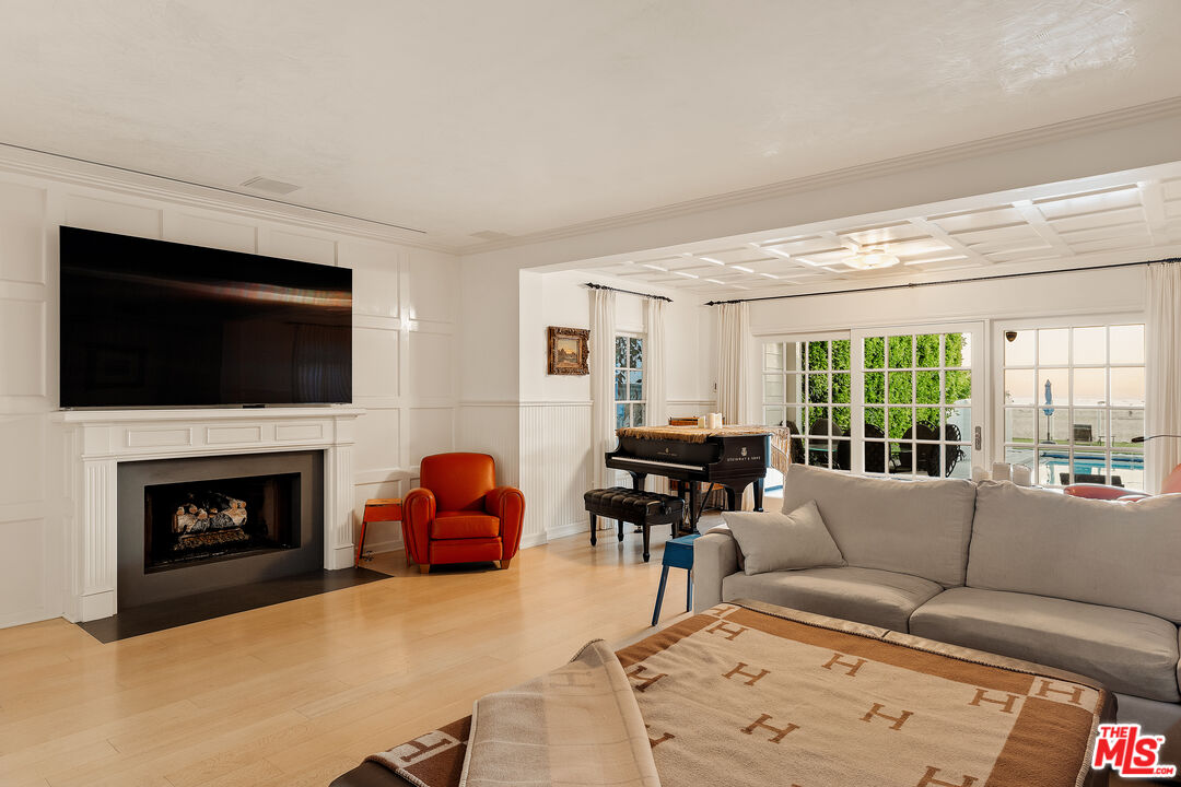 501 Palisades Beach Road Santa Monica, CA 90402 - Photo 7 of 29 a living room with furniture a fireplace and a flat screen tv