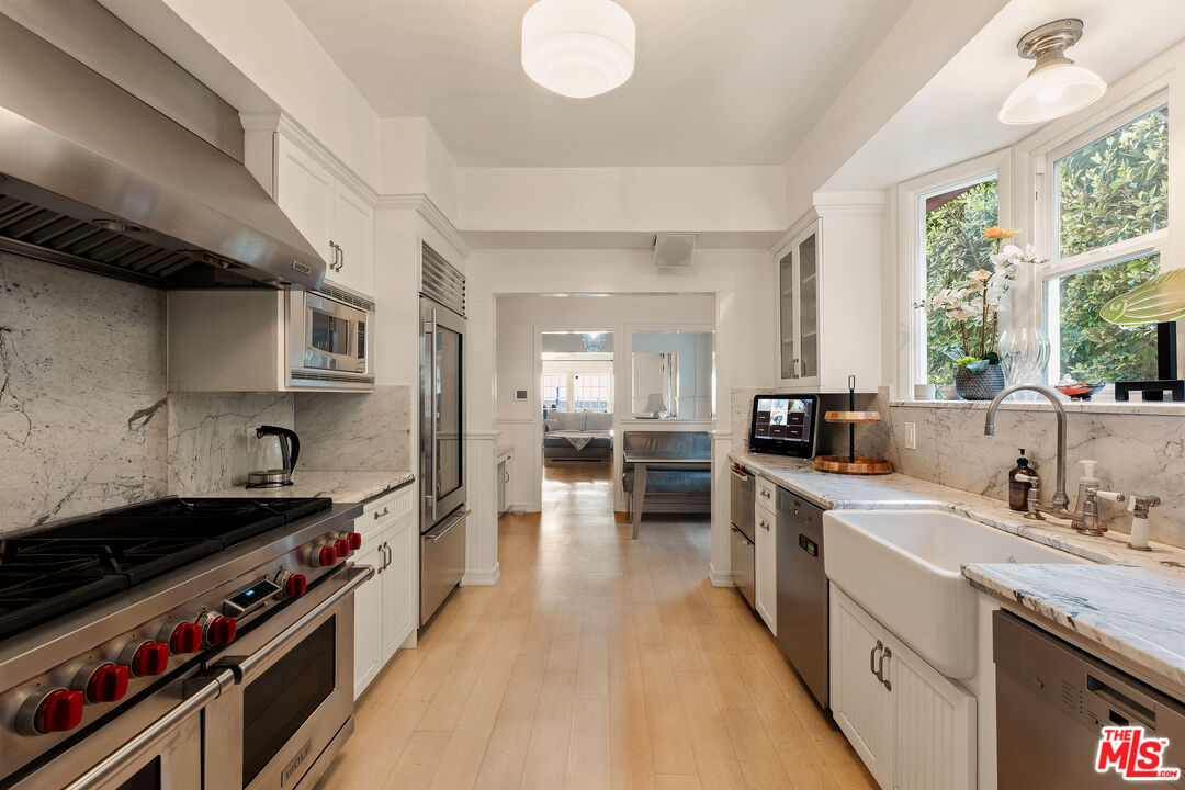 501 Palisades Beach Road Santa Monica, CA 90402 - Photo 10 of 29 a kitchen with a stove a sink and a refrigerator