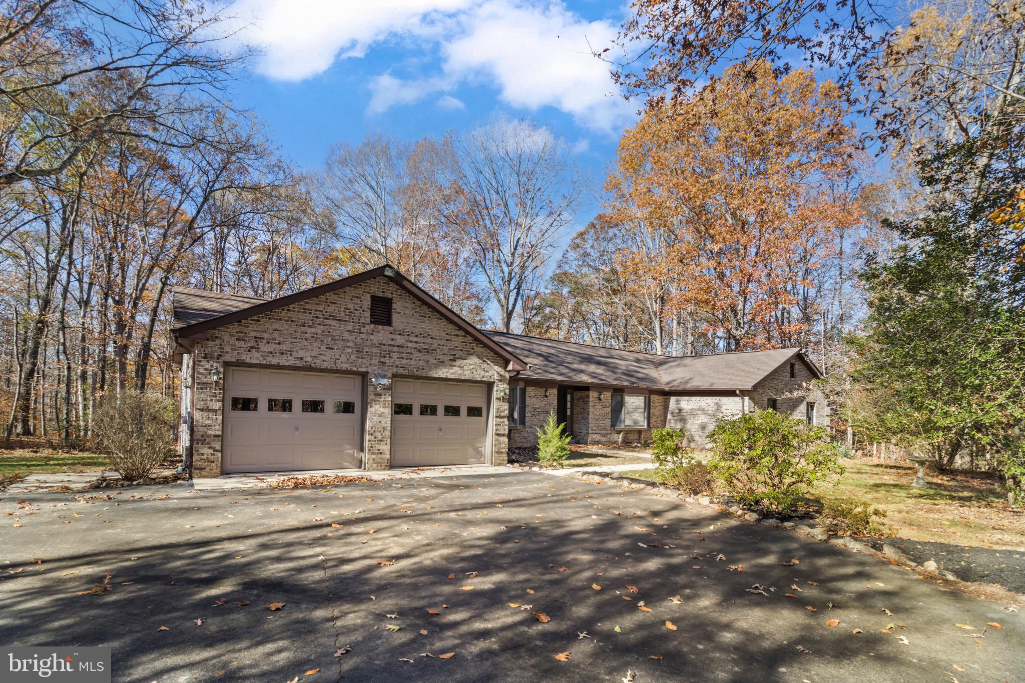 9675 Faith Baptist Church Road White Plains, MD 20695 - Photo 2 of 53 a backyard of a house with large trees and outdoor seating