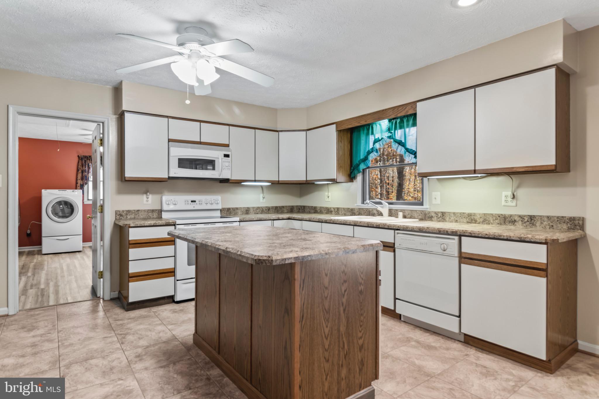 9675 Faith Baptist Church Road White Plains, MD 20695 - Photo 21 of 53 a kitchen with stainless steel appliances granite countertop a sink stove and refrigerator
