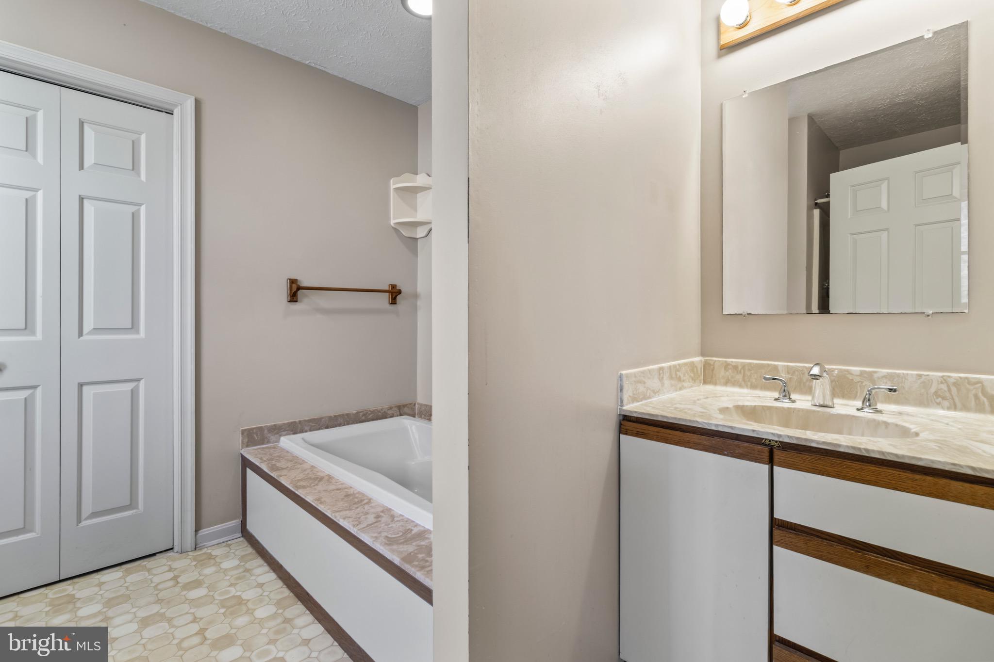 9675 Faith Baptist Church Road White Plains, MD 20695 - Photo 32 of 53 a bathroom with a tub sink and mirror
