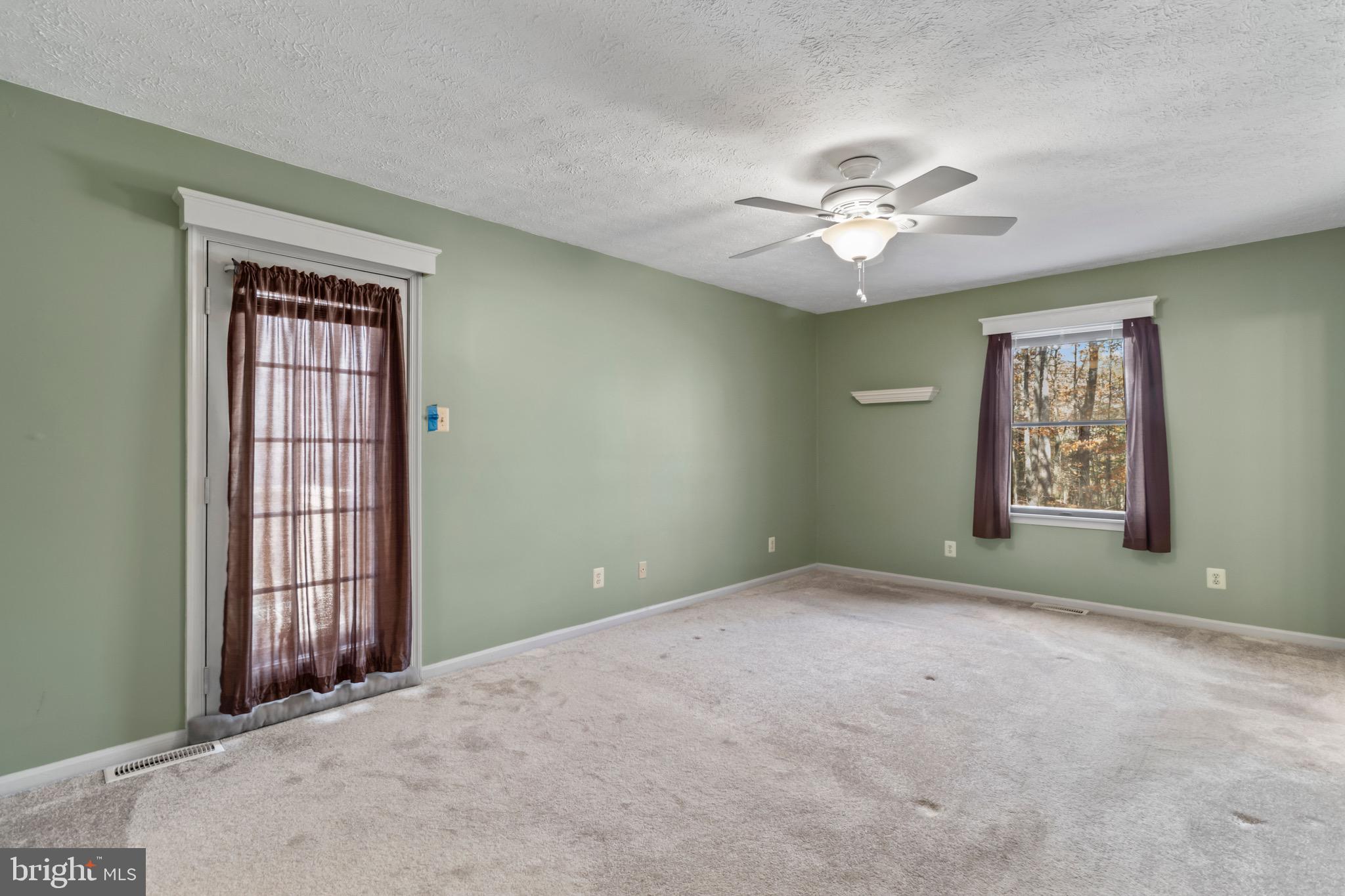 9675 Faith Baptist Church Road White Plains, MD 20695 - Photo 34 of 53 an empty room with windows and fan