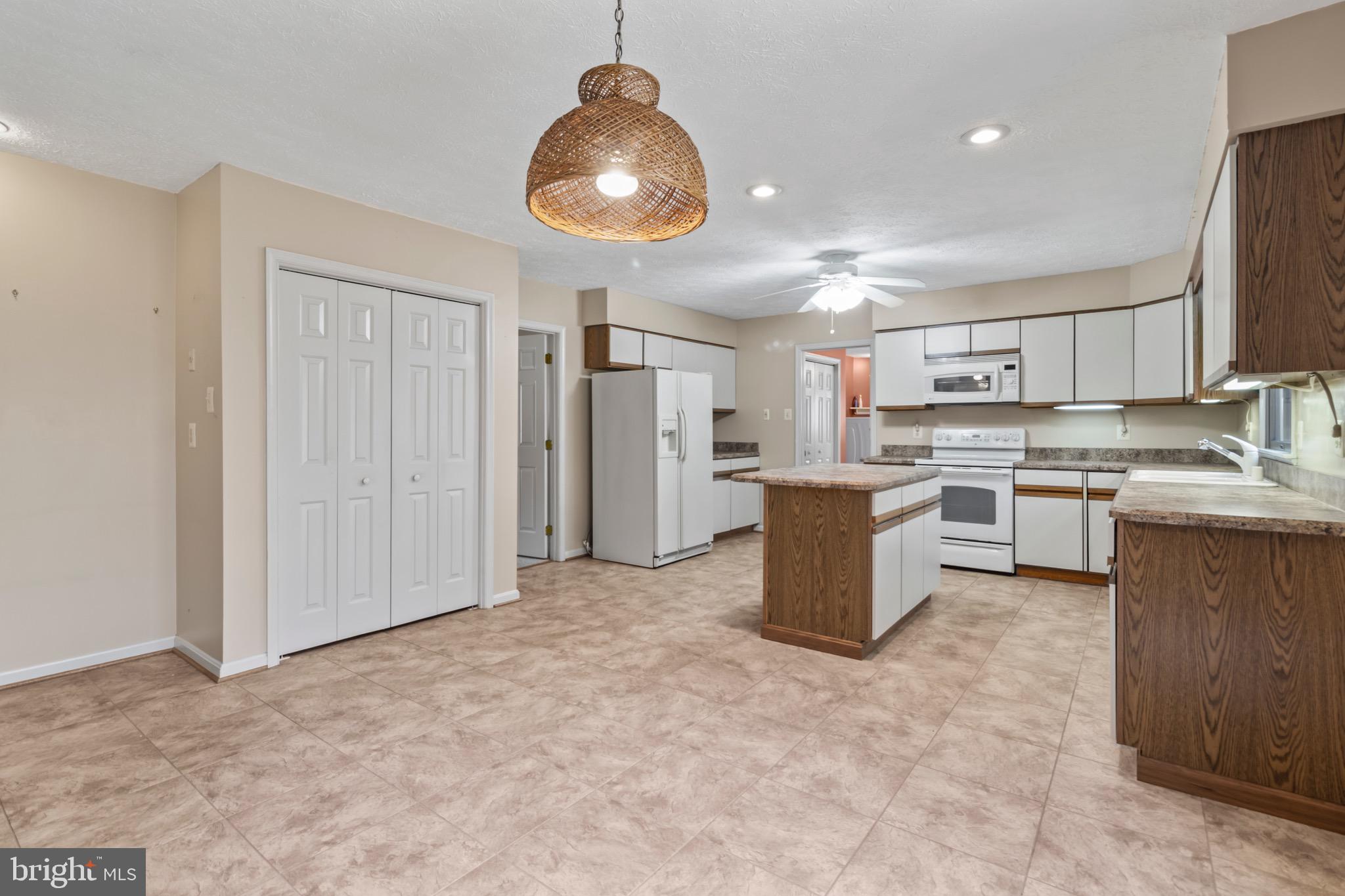 9675 Faith Baptist Church Road White Plains, MD 20695 - Photo 5 of 53 a kitchen with refrigerator and cabinets