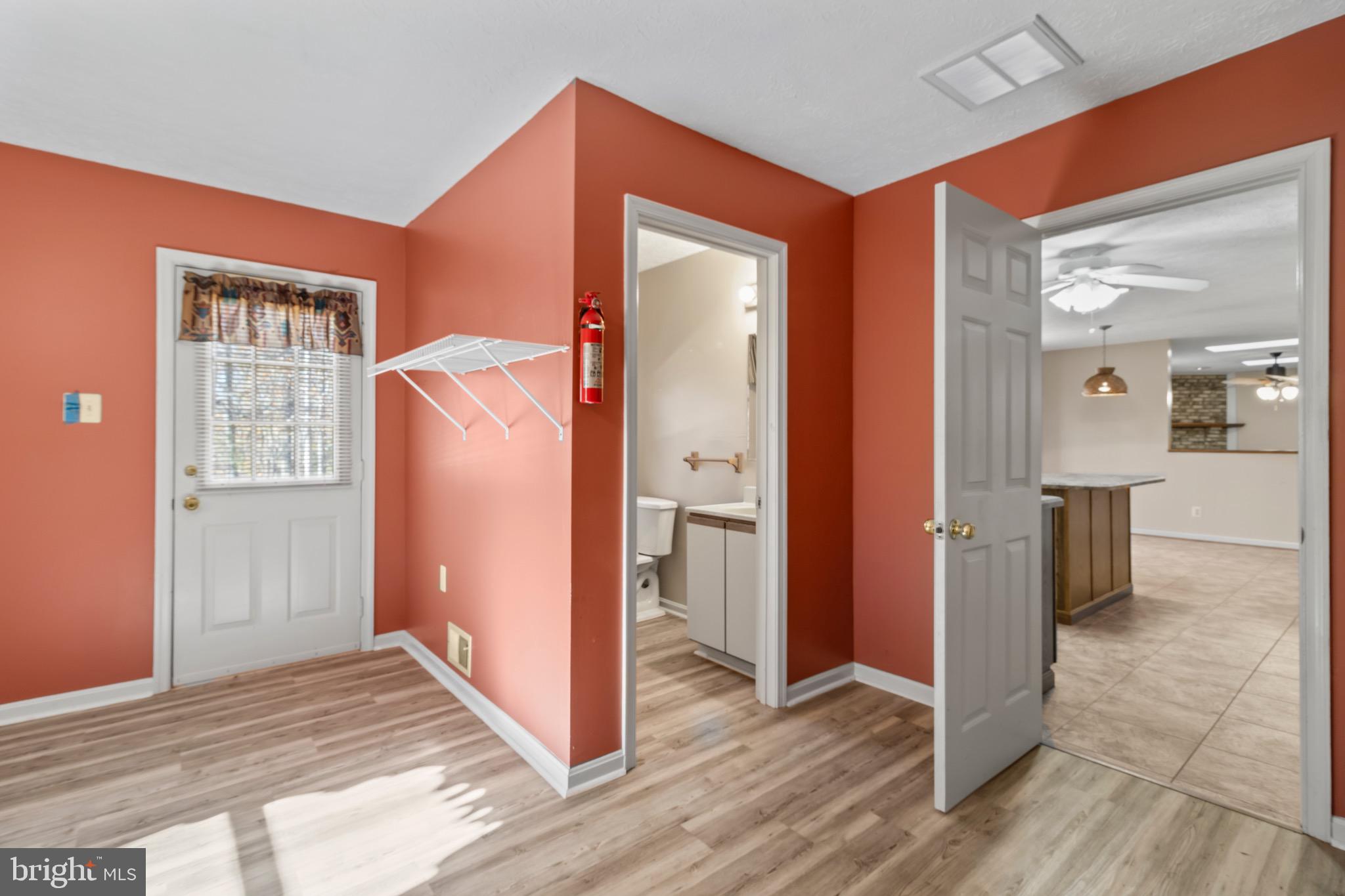 9675 Faith Baptist Church Road White Plains, MD 20695 - Photo 10 of 53 an empty room with wooden floor and a fireplace