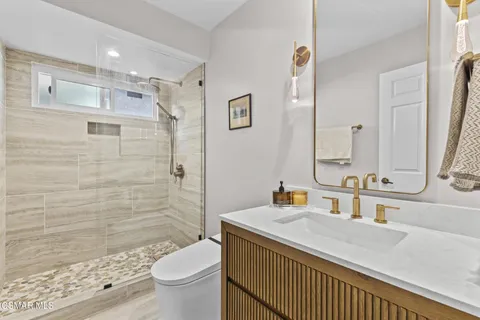 a bathroom with a sink toilet and shower