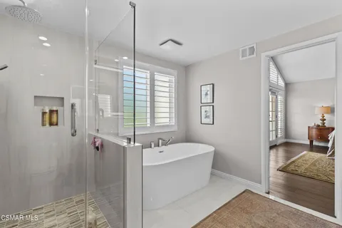 a bathroom with a bathtub and a shower