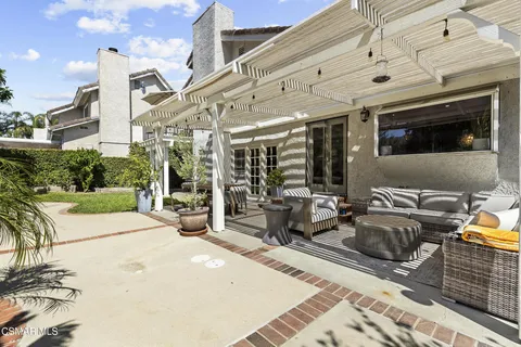 a view of a patio with table and chairs potted plants with wooden floor