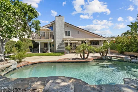 a view of a house with pool yard and sitting area