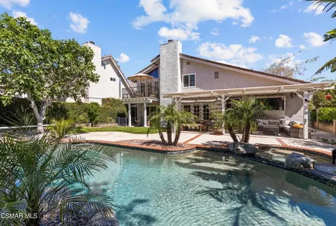 a view of house with swimming pool and outdoor space