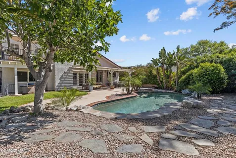 a view of a house with a backyard