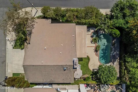 an aerial view of a house with a yard