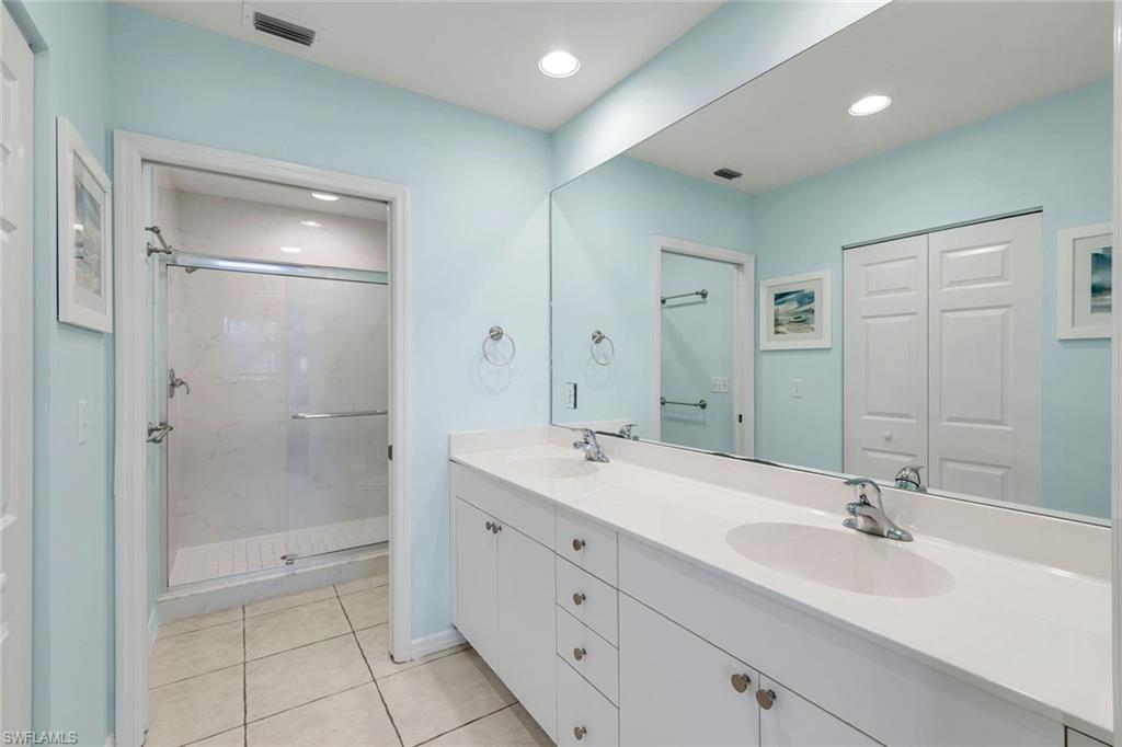 460 Launch Circle, Unit 202 Naples, FL 34108 - Photo 13 of 34 a bathroom with a double vanity sink mirror and shower