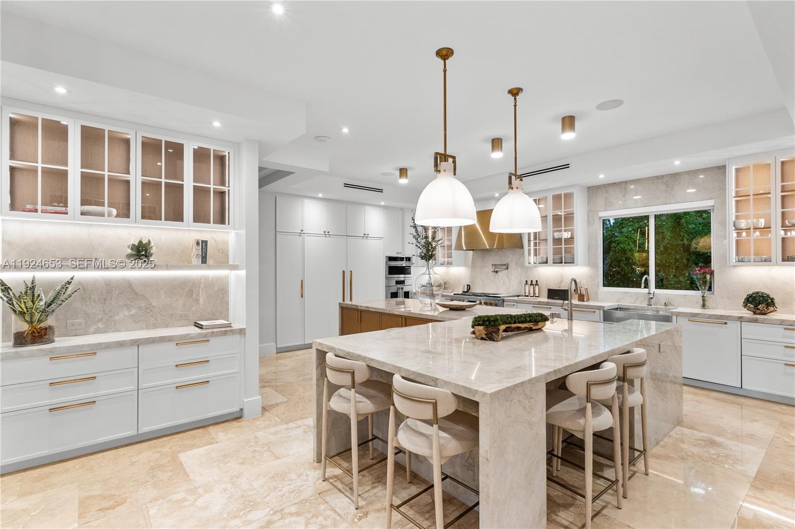 6080 Southwest 104th Street Pinecrest, FL 33156 - Photo 18 of 75 a kitchen with stainless steel appliances a stove a table and chairs
