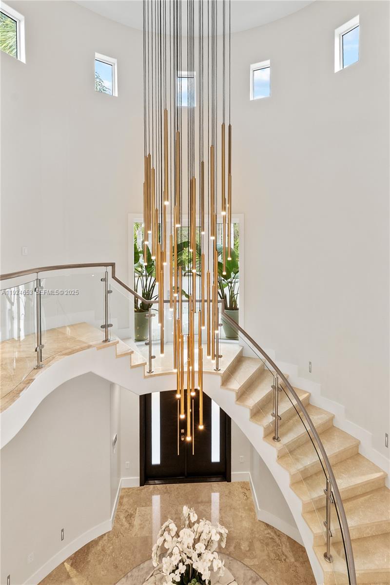 6080 Southwest 104th Street Pinecrest, FL 33156 - Photo 24 of 75 a living room with a bed and a table with potted plants