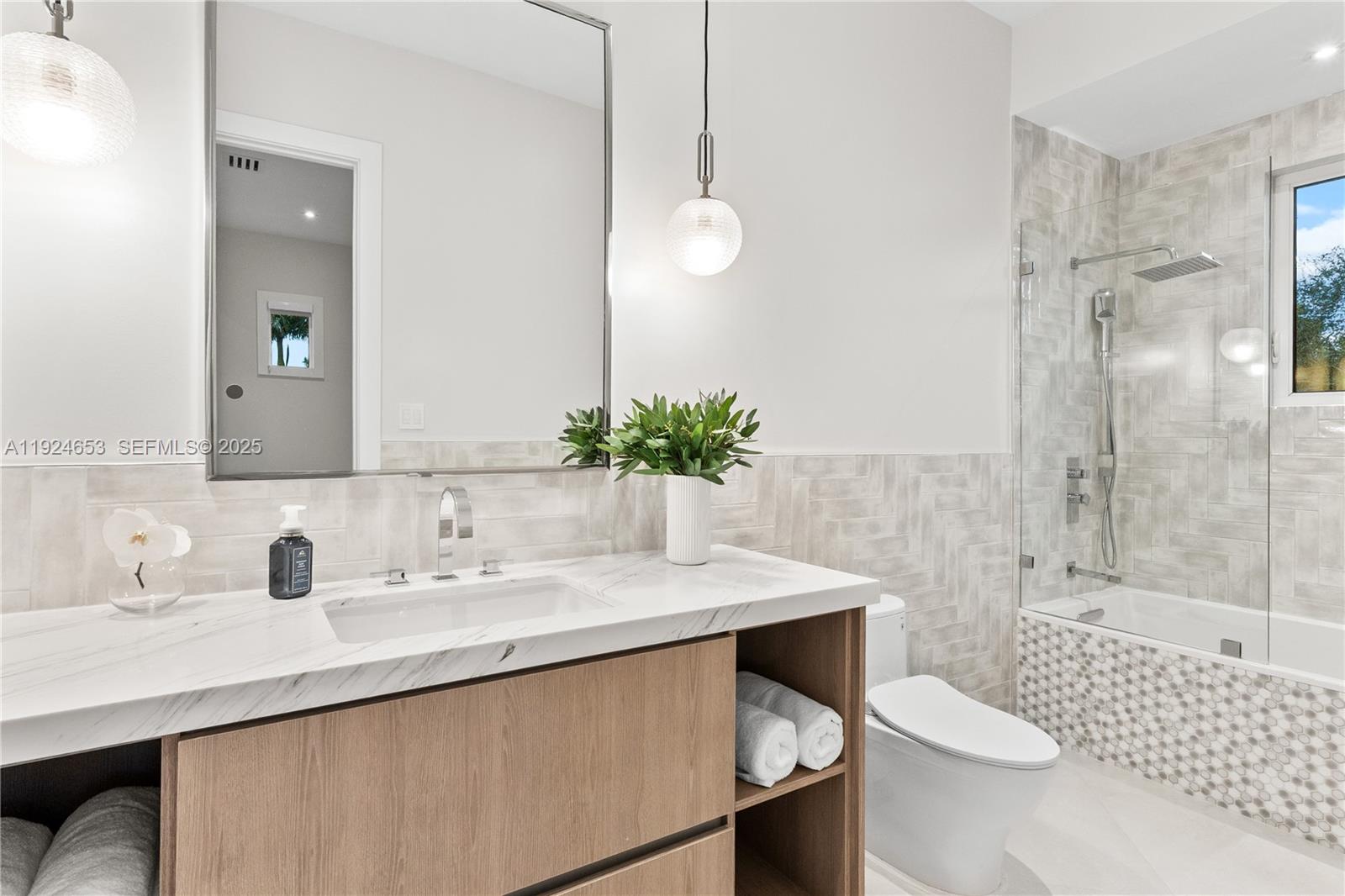 6080 Southwest 104th Street Pinecrest, FL 33156 - Photo 55 of 75 a bathroom with a sink a toilet and shower