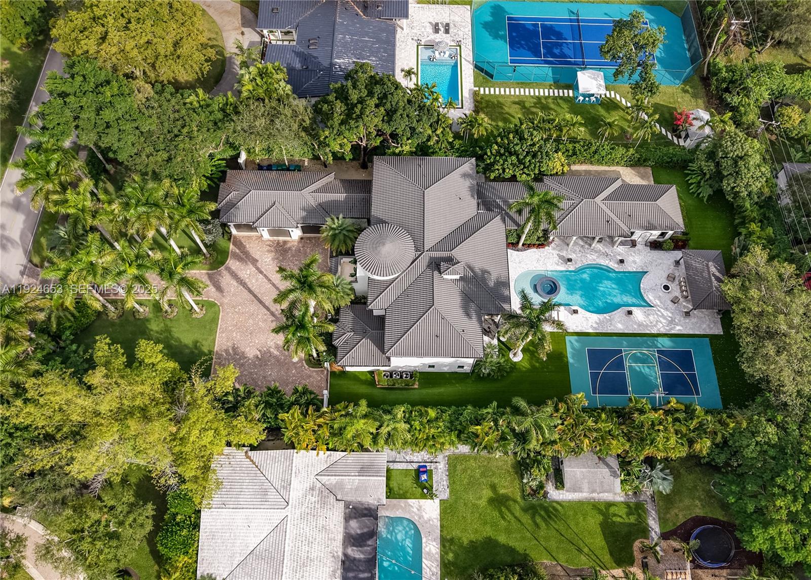 6080 Southwest 104th Street Pinecrest, FL 33156 - Photo 70 of 75 an aerial view of a house with a yard and lake view