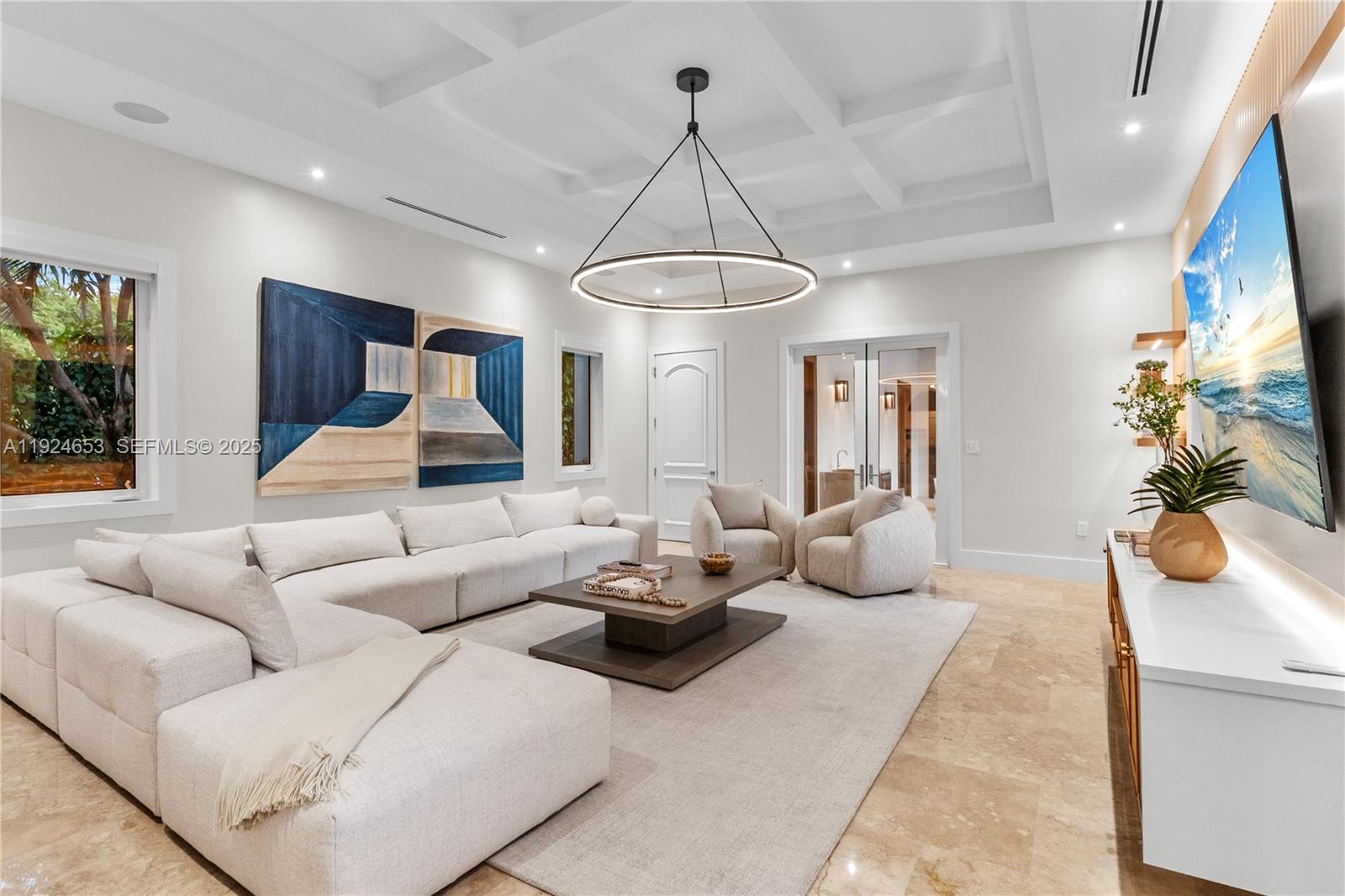 6080 Southwest 104th Street Pinecrest, FL 33156 - Photo 9 of 75 a living room with furniture a chandelier and a flat screen tv
