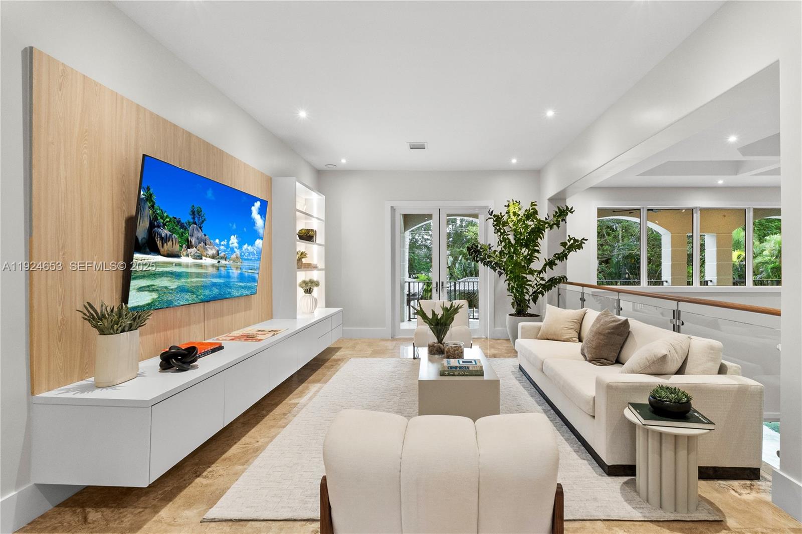 6080 Southwest 104th Street Pinecrest, FL 33156 - Photo 10 of 75 a living room with furniture flat screen tv and a large window