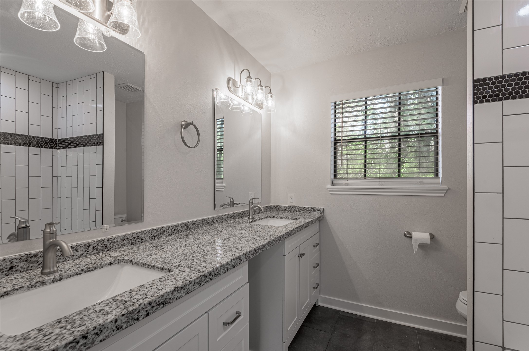 2401 Sycamore Avenue, Unit E2 Huntsville, TX 77340 - Photo 14 of 19 a bathroom with a granite countertop sink and a mirror