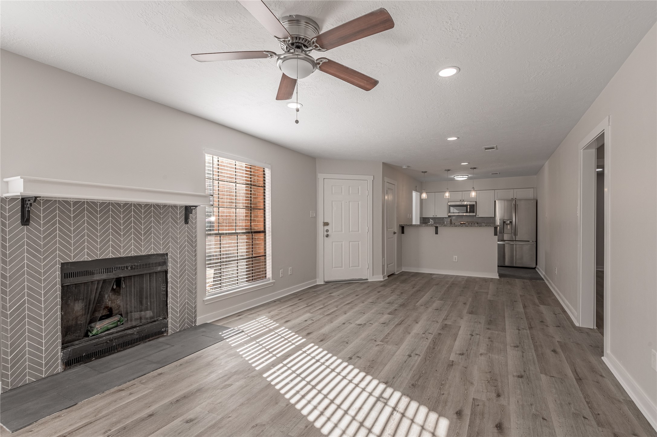 2401 Sycamore Avenue, Unit E2 Huntsville, TX 77340 - Photo 5 of 19 a view of a livingroom with wooden floor and a kitchen