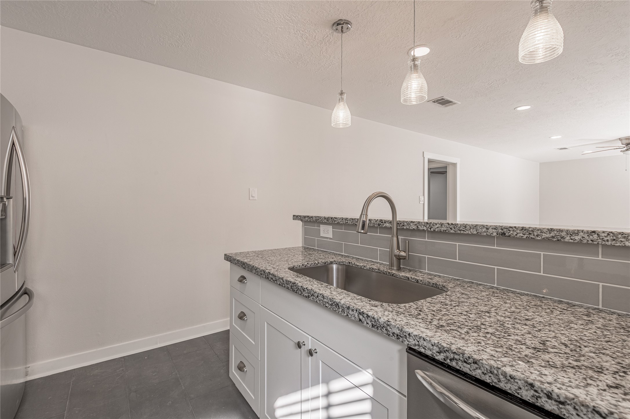 2401 Sycamore Avenue, Unit E2 Huntsville, TX 77340 - Photo 9 of 19 a kitchen with a sink and a mirror