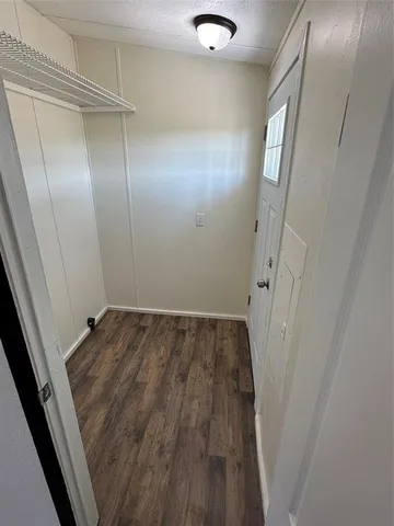 a view of a room with wooden floor