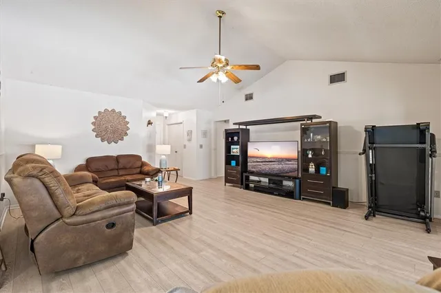 a view of a dining room with a table and chairs